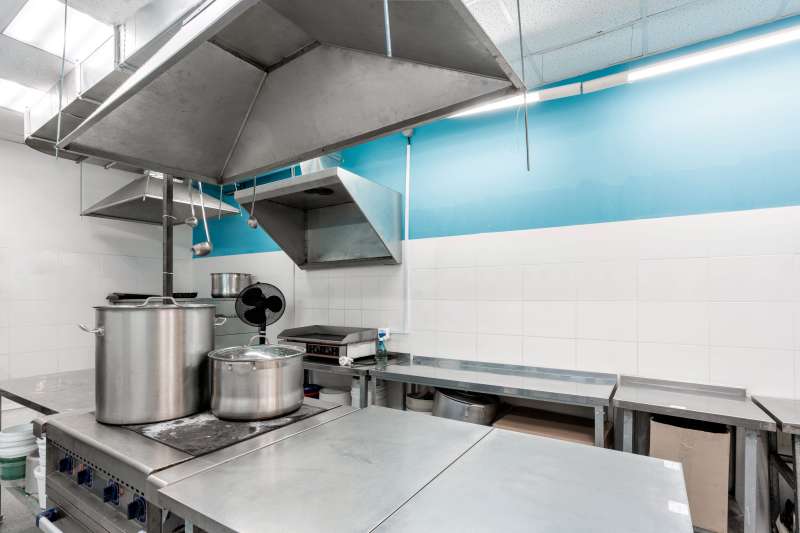 Fly Screens for Commercial Kitchens improving airflow and hygiene in a modern stainless steel food preparation area by Gozito UK